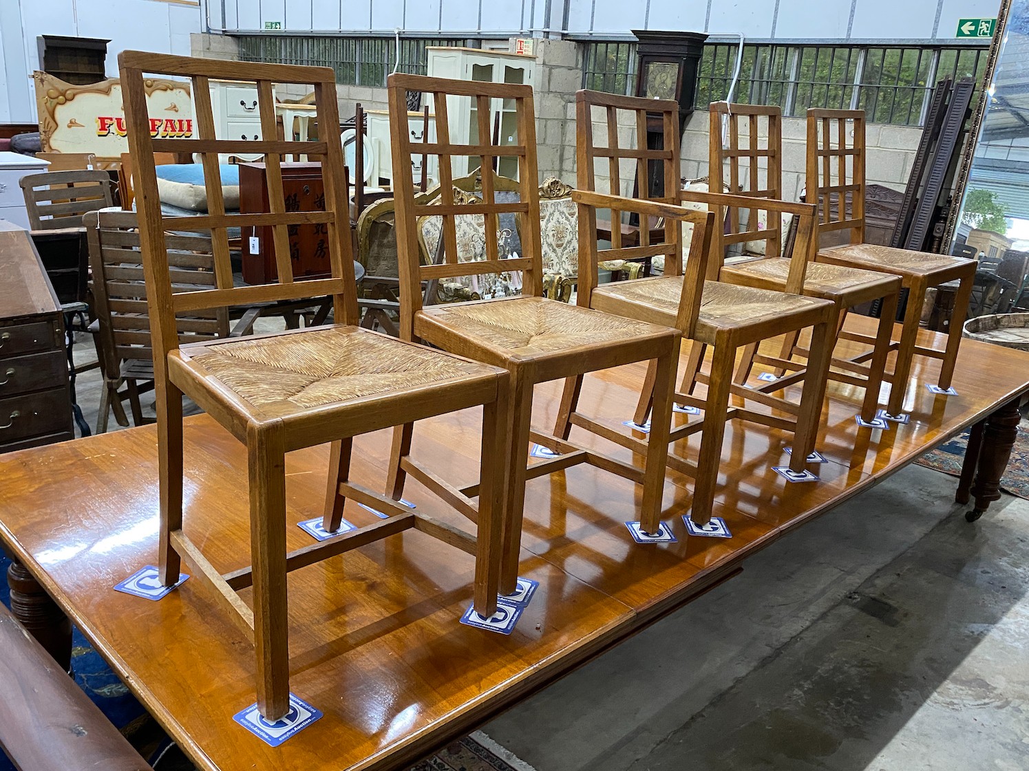 A set of five Heals Cotswold oak dining chairs, including one carver